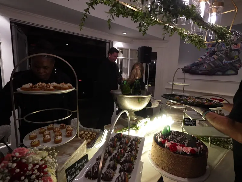 Dessert display with cake and small sweets at a reception