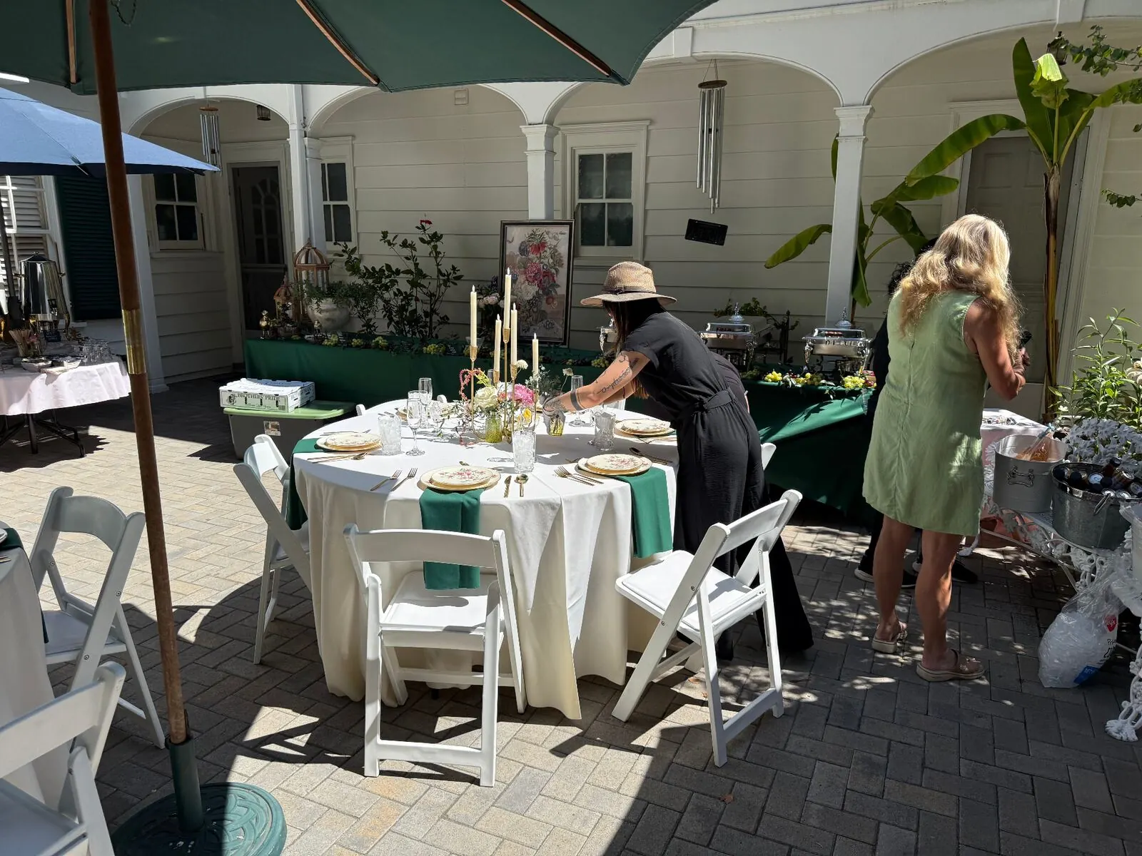 Courtyard rounds finished in emerald cloths with upgraded rentals, stemware and complete settings — elevated tablescape rentals through our San Ramon catering service