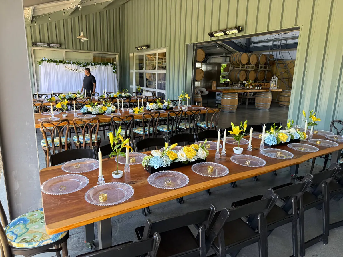 Low garden-style floral centerpieces in blush and ivory on guest tables for a Livermore wine country wedding, florals by Winslow's Catering Livermore
