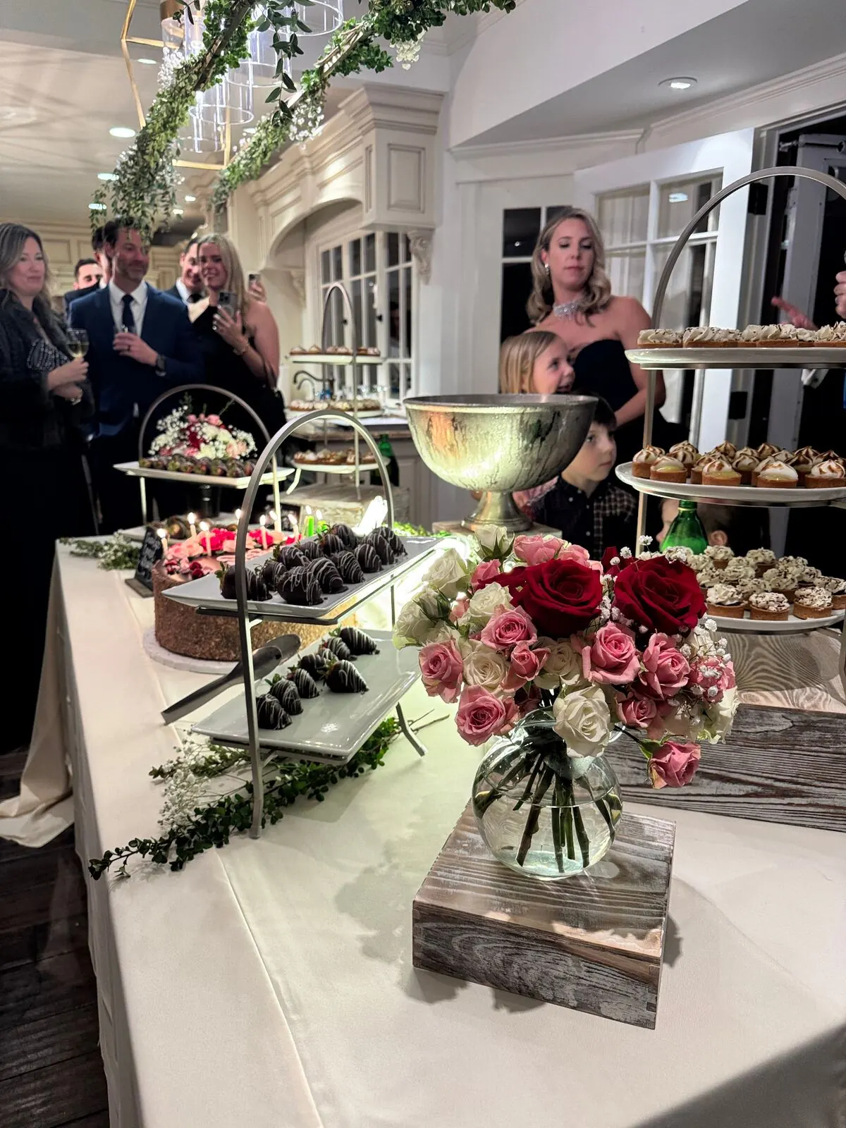 Wedding dessert table with tiered cake, mini pastries and chocolate-dipped strawberries at a Livermore Valley winery reception by Winslow's Catering Livermore